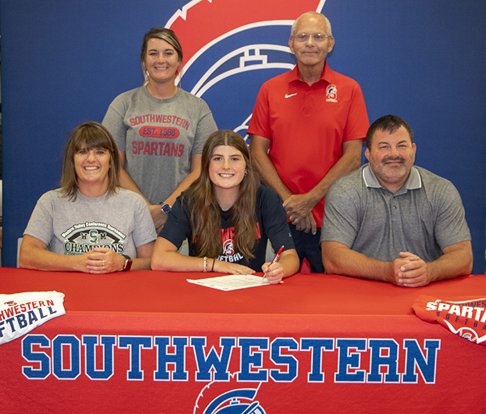 Madison Chesnut and her parents and Southwestern coaches as she signs with the Spartans