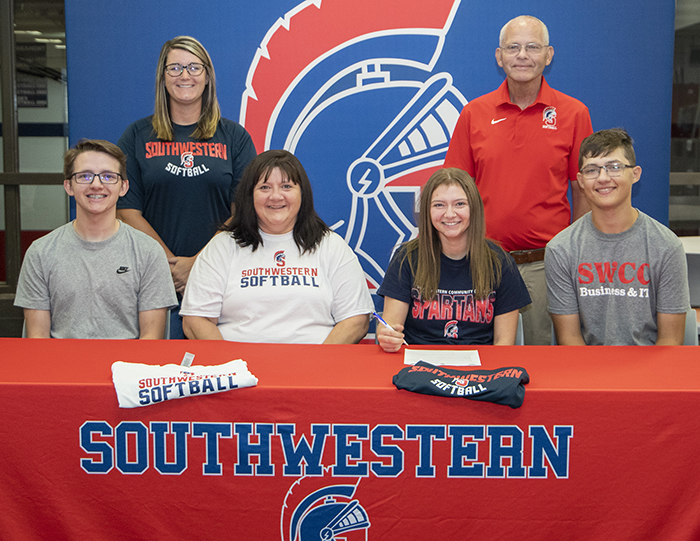 Mallory Moyer signing with Spartan softball. Pictured with her family and the SWCC coaches.