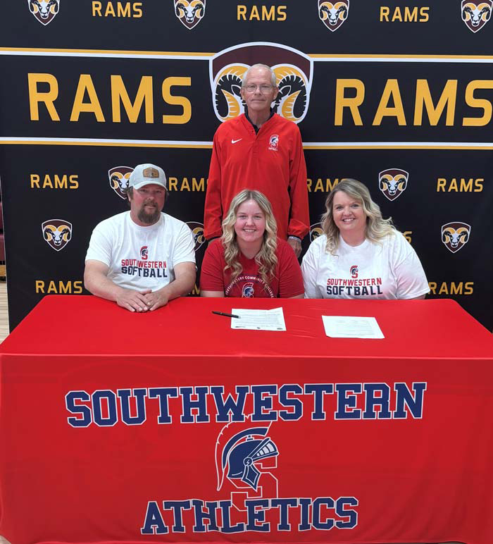 Sitting (L to R) – Bill Kovarna, Ava’s father; Ava Kovarna; and Linda Kovarna, Ava’s mother. Standing - Danny Jensen, Southwestern head softball coach.