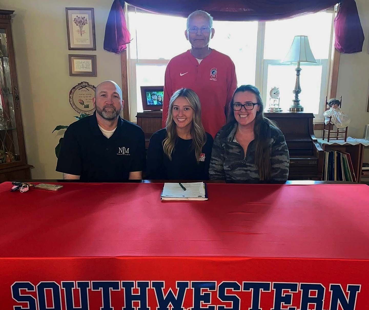 Front row – Josh Costello, Laura’s stepfather; Laura Lippincott; and Amorette Costello, Laura’s mother.
Back row – Danny Jensen, Southwestern head softball coach.
