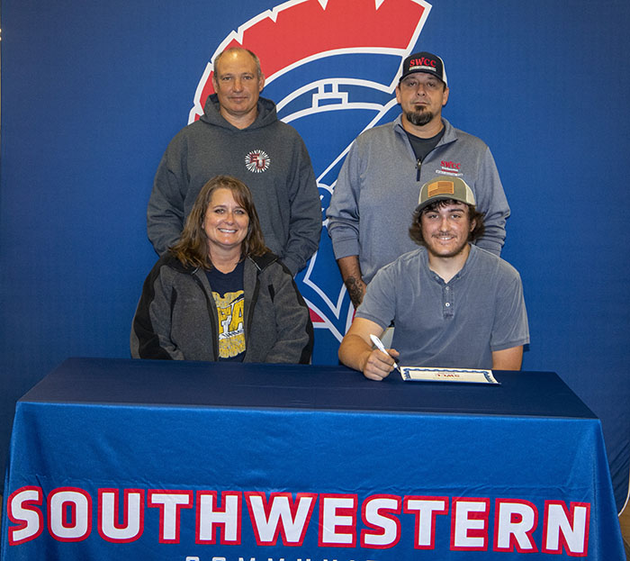 Sitting: Melanie and Ethan Mitchell.
Standing: Scott Mitchell and Josh Purdy, SWCC sports shooting coach