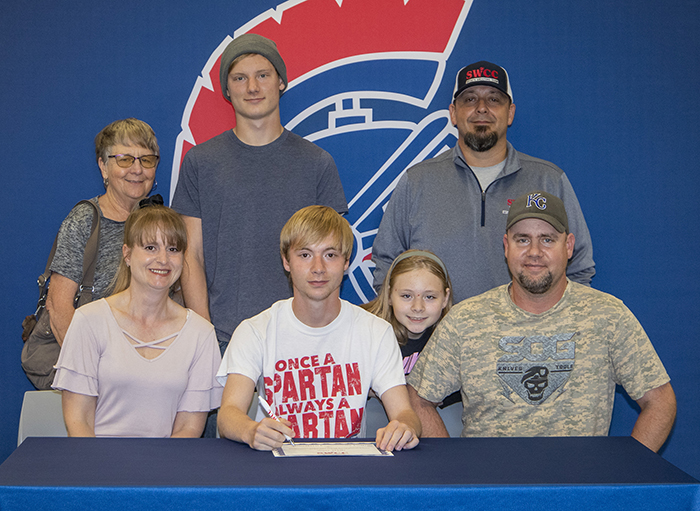 Sitting (L to R): Cora Haley, Nathaniel's mother; Nathaniel Wells; and Frank Wells, Nathaniel's father.
Standing: Lee Wells, Nathaniel's grandmother; Chris Wells, Nathaniel's brother; Kaylee Wells, Nathaniel's sister (leaning); and Josh Purdy, Southwestern sports shooting coach.