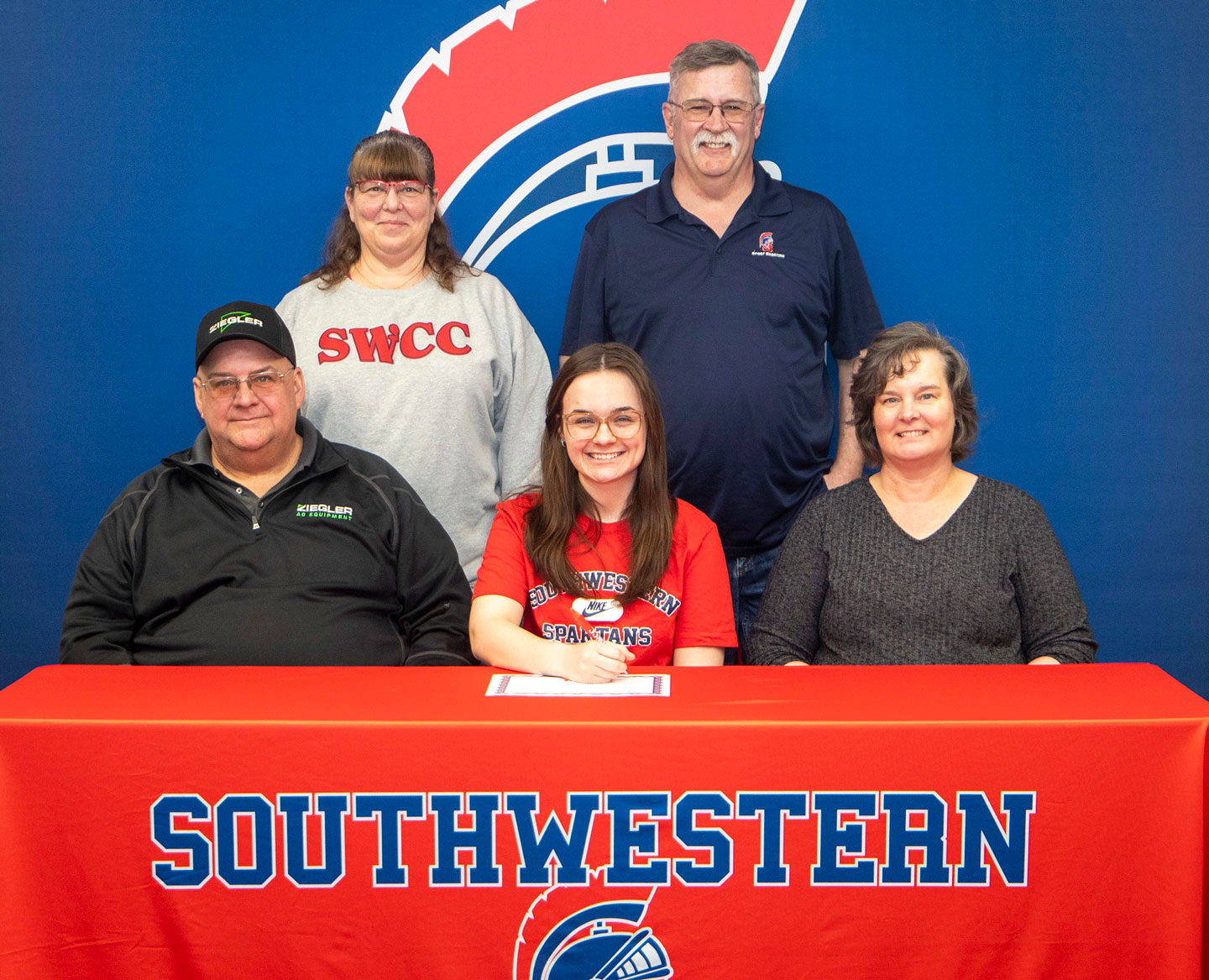 In Photo: Sitting – Phil, Erin, and Rebekah Kinney. Standing – Mark Johnson, SWCC sports shooting coach, and Sharon Swanson, SWCC sports shooting program volunteer.